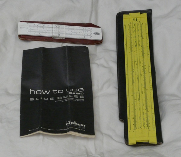 Two slide rules and an instruction manual.
